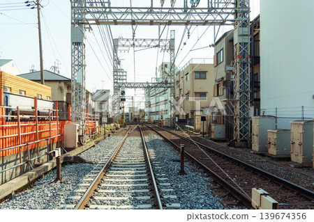 Urban railway track passing through residential building in Japan 139674356