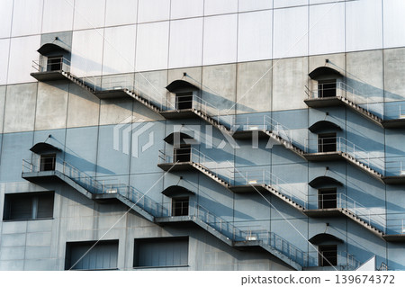 Geometric harmony of fire escapes stair with shadow and light Geometric harmony of fire escapes stair with shadow and light 139674372