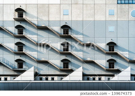 Geometric harmony of fire escapes stair with shadow and light Geometric harmony of fire escapes stair with shadow and light 139674373