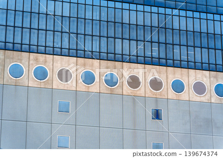 Modern architectural building with circular and square windows futuristic facade design 139674374
