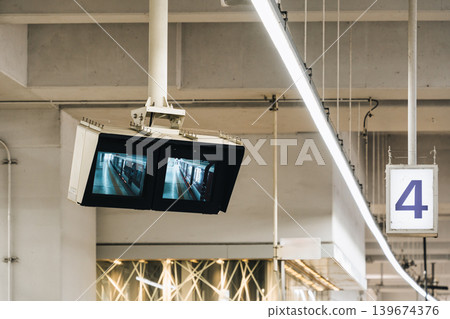 Surveillance monitors showing train arrival at platform in urban transit station Surveillance monitors showing train arrival at platform in urban transit station 139674376