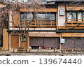 Traditional wooden machiya house facade with bare tree in Kyoto 139674440