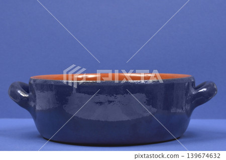 Blue Clay Cooking Pot on Blue Background Blue Clay Cooking Pot on Blue Background 139674632