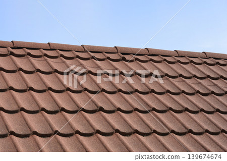 Close up of brown stone coated metal roof tiles Close up of brown stone coated metal roof tiles 139674674