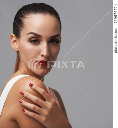Makeup, woman in portrait for cosmetics and manicure in studio, nail polish and lashes with skin and beauty on grey background. Red lipstick, nails and glamour, mascara for confidence and elegance Makeup, woman in portrait for cosmetics and manicure in studio, nail polish and lashes with skin and beauty on grey background. Red lipstick, nails and glamour, mascara for confidence and elegance 139674724