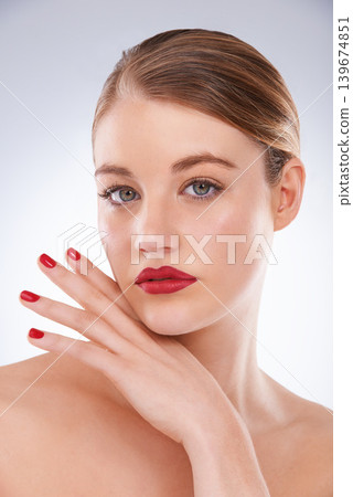 Woman, portrait and makeup in studio with red lipstick for cosmetics, beauty and aesthetic with nail polish. Model, person and confidence with skincare, glowing face and wellness on white background 139674851
