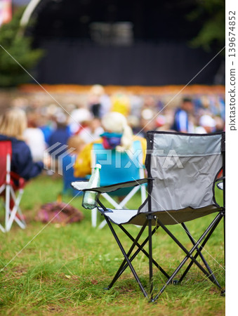 Outdoor, concert and people with camping chair, festival and blur background with audience. Crowd, outside and seat with party, social event and environment with musical celebration, break and grass Outdoor, concert and people with camping chair, festival and blur background with audience. Crowd, outside and seat with party, social event and environment with musical celebration, break and grass 139674852