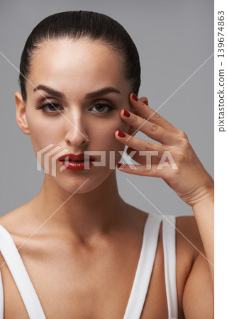 Face, makeup and woman for beauty with manicure, nail polish and skin with cosmetics isolated on grey background. Red lipstick, color nails and model in portrait with confidence in studio and glamour Face, makeup and woman for beauty with manicure, nail polish and skin with cosmetics isolated on grey background. Red lipstick, color nails and model in portrait with confidence in studio and glamour 139674863
