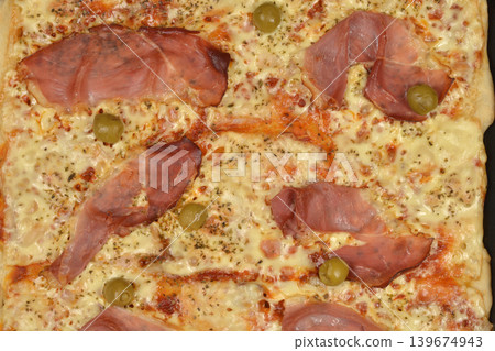 Homemade Pizza with Ham and Olives Homemade Pizza with Ham and Olives 139674943