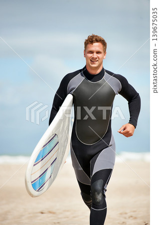 Surfer, man with surfboard and run on beach for extreme sports, wet suit and adventure in the sun. Summer vacation with adventure and surfing in nature, ocean and exercise with hobby in Australia Surfer, man with surfboard and run on beach for extreme sports, wet suit and adventure in the sun. Summer vacation with adventure and surfing in nature, ocean and exercise with hobby in Australia 139675035
