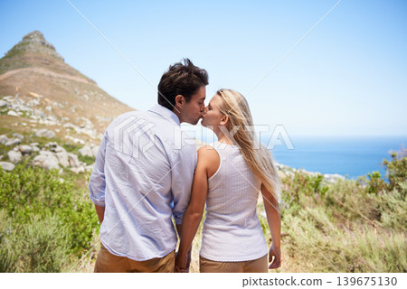 Couple, love and kiss on mountains for travel, journey and holiday in nature for summer and valentines day celebration. Back of romantic people on date, hiking and tourism in Cape Town, South Africa Couple, love and kiss on mountains for travel, journey and holiday in nature for summer and valentines day celebration. Back of romantic people on date, hiking and tourism in Cape Town, South Africa 139675130