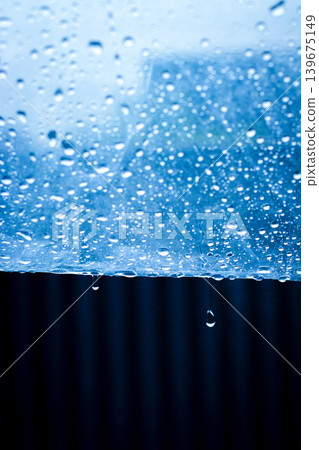 Raindrops dripping from an umbrella on a rainy day Raindrops dripping from an umbrella on a rainy day 139675149