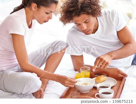 Couple, love and eating breakfast together for bonding, healthy meal and relaxing in bedroom. People, food and nutrition on diet at home, hunger and romance on anniversary for marriage milestone 139675213