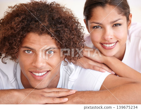 Couple, portrait and happy relaxing in bed on weekend, comfortable and lazy or resting in apartment. People, love and smiling in bedroom, bonding and romance on holiday or vacation in Amsterdam 139675234