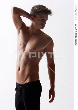 Topless, natural and masculine with body of man in studio on white background for health or wellness. Aesthetic, skin or stomach and young shirtless model in jeans for hygiene and satisfaction Topless, natural and masculine with body of man in studio on white background for health or wellness. Aesthetic, skin or stomach and young shirtless model in jeans for hygiene and satisfaction 139675332