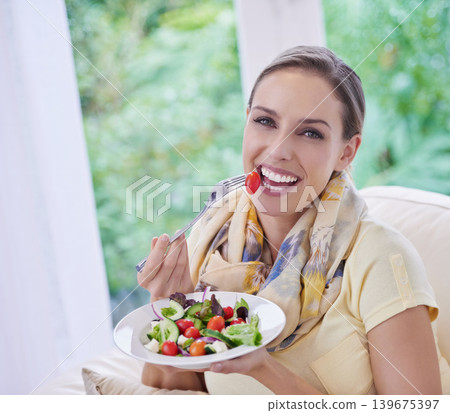 Woman, eating salad and food for nutrition, vegetables and lunch with happiness in portrait. Diet, wellness and healthy vegan meal for cholesterol with smile, detox and snack for dinner at home Woman, eating salad and food for nutrition, vegetables and lunch with happiness in portrait. Diet, wellness and healthy vegan meal for cholesterol with smile, detox and snack for dinner at home 139675397