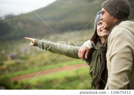 Travel, hiking and pointing with couple in mountains together for love, dating or sightseeing. Smile, environment or view with happy young man and woman in nature for adventure, holiday or vacation 139675412
