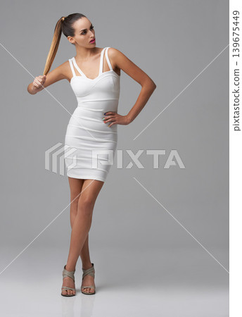 Woman, hair and beauty with dress in studio, cosmetics and high heels for glamour on grey background. Stylish, trendy and fashion model with mockup space, makeup and keratin treatment with haircare Woman, hair and beauty with dress in studio, cosmetics and high heels for glamour on grey background. Stylish, trendy and fashion model with mockup space, makeup and keratin treatment with haircare 139675449
