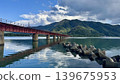 A mountainous landscape along a river, with stone platforms and iron bridges lined up. 139675953