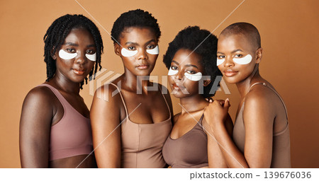 Face, happy or black women with eye patch for skincare or beauty isolated on brown background. Studio, smile or African models with facial collagen pads, dermatology product or anti aging cosmetics Face, happy or black women with eye patch for skincare or beauty isolated on brown background. Studio, smile or African models with facial collagen pads, dermatology product or anti aging cosmetics 139676036