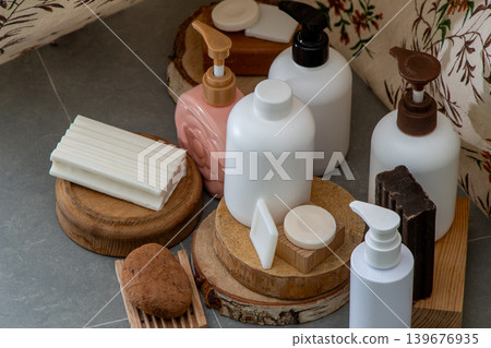 Soap and Lotion Bottles. Natural Skincare Collection with Soaps Bars and Cosmetic Bottle on Wooden Podiums 139676935