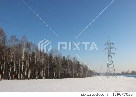 High voltage transmission line tower in winter landscape High voltage transmission line tower in winter landscape 139677036
