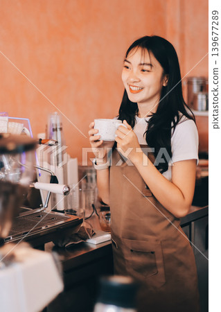Young woman at barista school learning how to make espresso coffee. Young woman at barista school learning how to make espresso coffee. 139677289