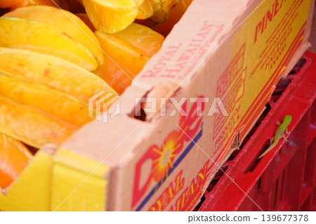 Ripe yellow mangoes lined up in carton boxes at a Hawaiian market. Ripe yellow mangoes lined up in carton boxes at a Hawaiian market. 139677378