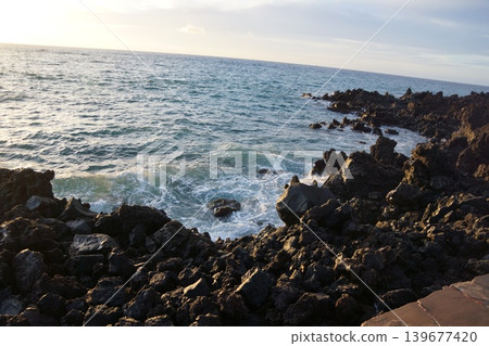 Silhouette of a person standing on a beach at sunset on the Big Island of Hawaii Silhouette of a person standing on a beach at sunset on the Big Island of Hawaii 139677420
