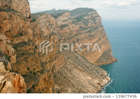 Majestic coastal cliffs overlooking azure sea and rugged landscape Majestic coastal cliffs overlooking azure sea and rugged landscape 139677436