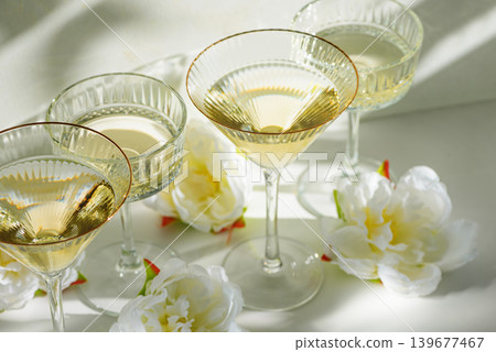 Champagne Glasses with White Peonies ib Sunlight Champagne Glasses with White Peonies ib Sunlight 139677467