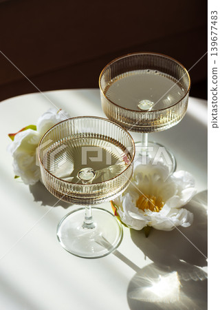Champagne Glasses with Flowers under Sunlight. 139677483