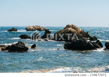 Scenic rocky seascape with clear blue water and sunny sky Scenic rocky seascape with clear blue water and sunny sky 139677971