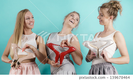 Three women showing high heels shoes Three women showing high heels shoes 139678464