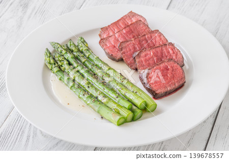 Juicy Medium Rare Steak Served With Asparagus And Lemon Butter Sauce Elegantly Juicy Medium Rare Steak Served With Asparagus And Lemon Butter Sauce Elegantly 139678557