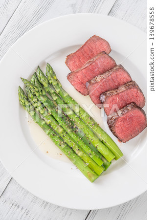 Juicy Medium Rare Steak Served With Asparagus And Lemon Butter Sauce Elegantly Juicy Medium Rare Steak Served With Asparagus And Lemon Butter Sauce Elegantly 139678558