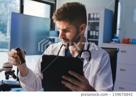 Attractive student of chemistry working in laboratory Attractive student of chemistry working in laboratory 139678842