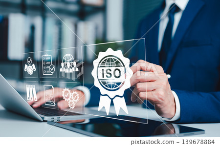 ISO certification standards and compliance management concept. Business professional reviewing ISO badge, audit icon, and quality documents representing certification control, verification, governance ISO certification standards and compliance management concept. Business professional reviewing ISO badge, audit icon, and quality documents representing certification control, verification, governance 139678884