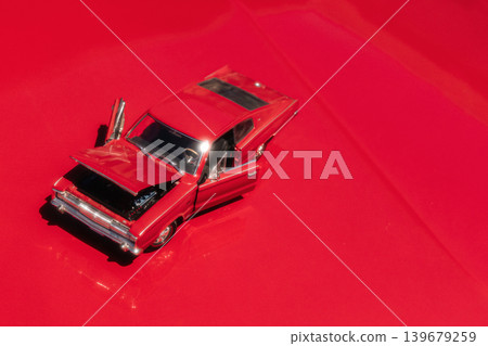 Berlin, Germany - May 2, 2026: Red model car on classic Dodge hood Berlin, Germany - May 2, 2026: Red model car on classic Dodge hood 139679259