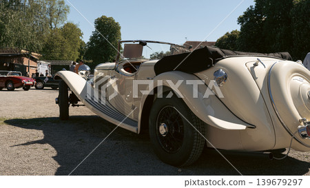 Berlin, Germany - May 2, 2026: Cream Vintage Roadster Rear Side View Berlin, Germany - May 2, 2026: Cream Vintage Roadster Rear Side View 139679297