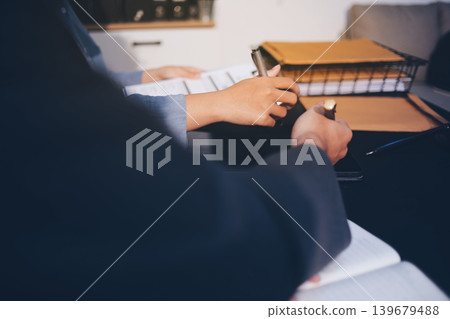 Lawyer explained to the client about the law that must be brought against the court case. Lawyer explained to the client about the law that must be brought against the court case. 139679488