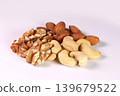 Three types of nuts (walnuts, cashews, and almonds) against a white background. 139679522