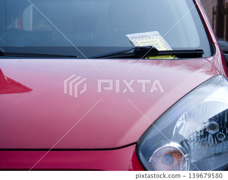 Driver finds parking ticket on windshield of car Driver finds parking ticket on windshield of car 139679580