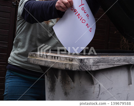Woman putting opnions in the trash bin Woman putting opnions in the trash bin 139679588