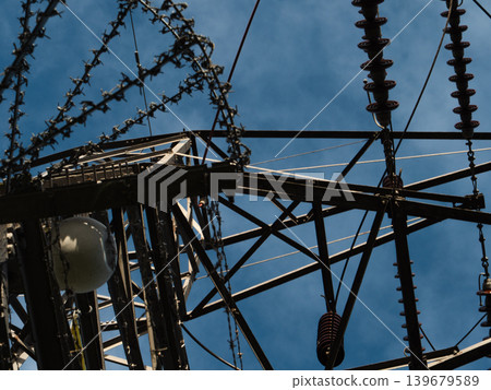 Looking up at electric pylon structure blue sky Looking up at electric pylon structure blue sky 139679589