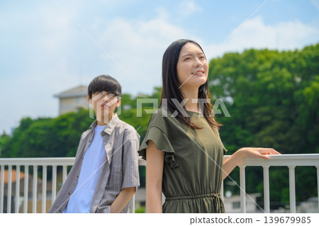 A woman and a man looking up outdoors 139679985