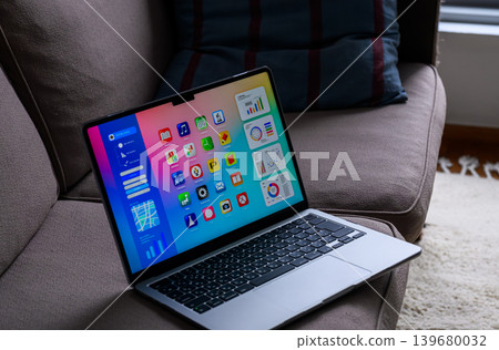 Laptop on the sofa with colorful app screens 139680032