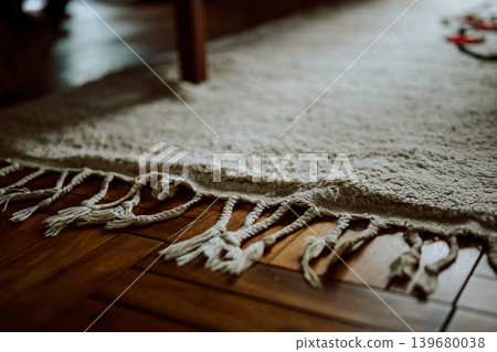A fringed rug laid on the floor 139680038