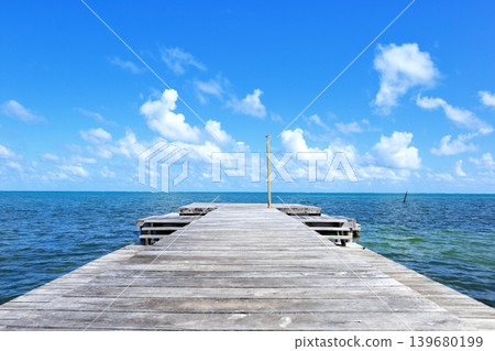 Caye Caulker, a Caribbean paradise: an old wooden pier and a panoramic view of the blue sky. 139680199