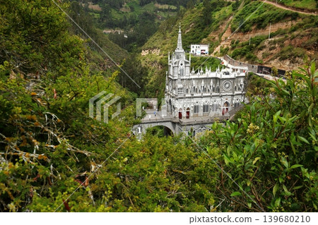 A hidden gem in Colombia, South America: The Las Lajas Church nestled in a valley and surrounded by lush greenery. 139680210